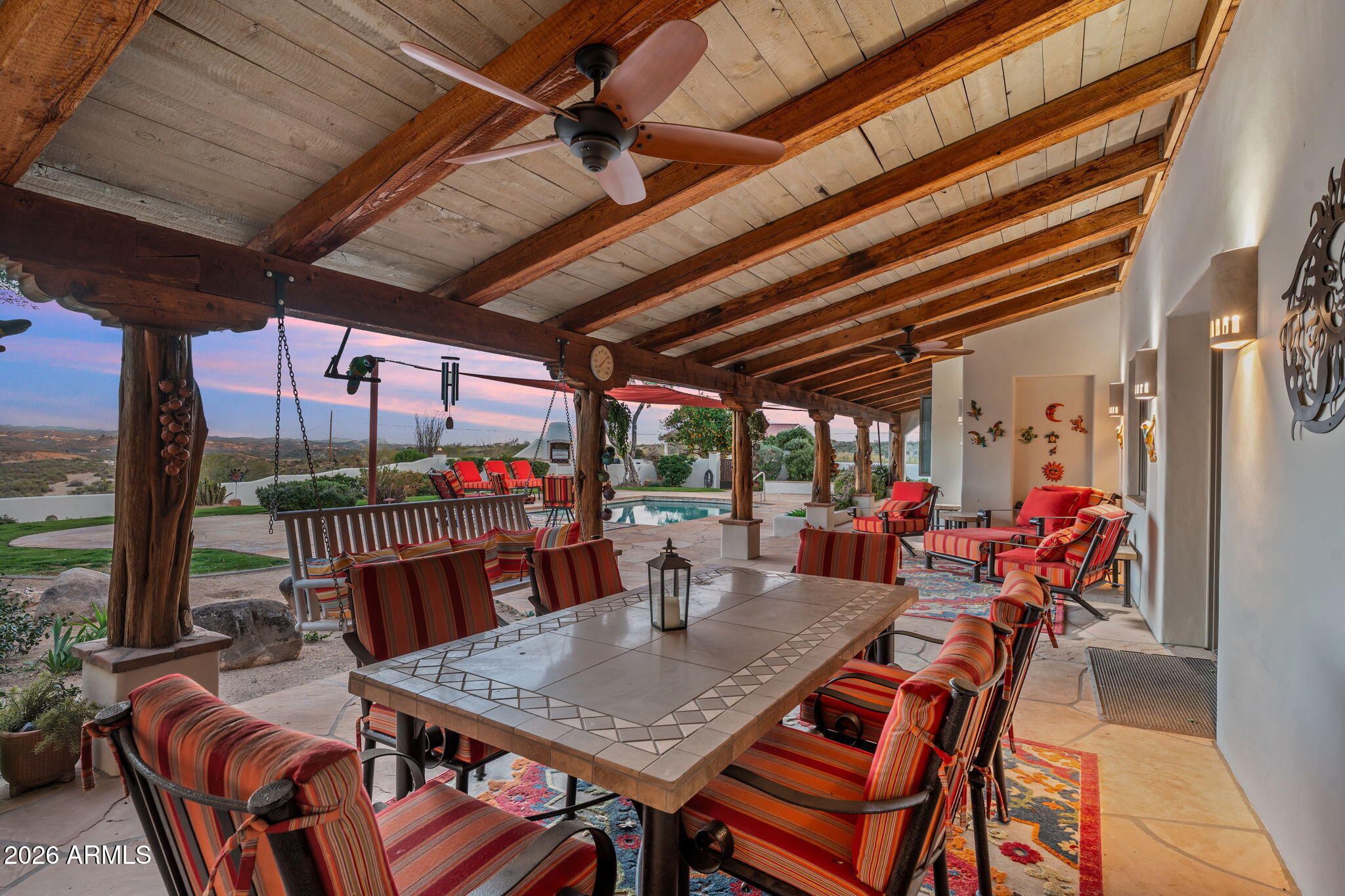 18210 Moonlight Mesa Road Wickenburg, AZ 85390 - Photo 42 of 141 a view of a patio with a table chairs and a couple of flower plants