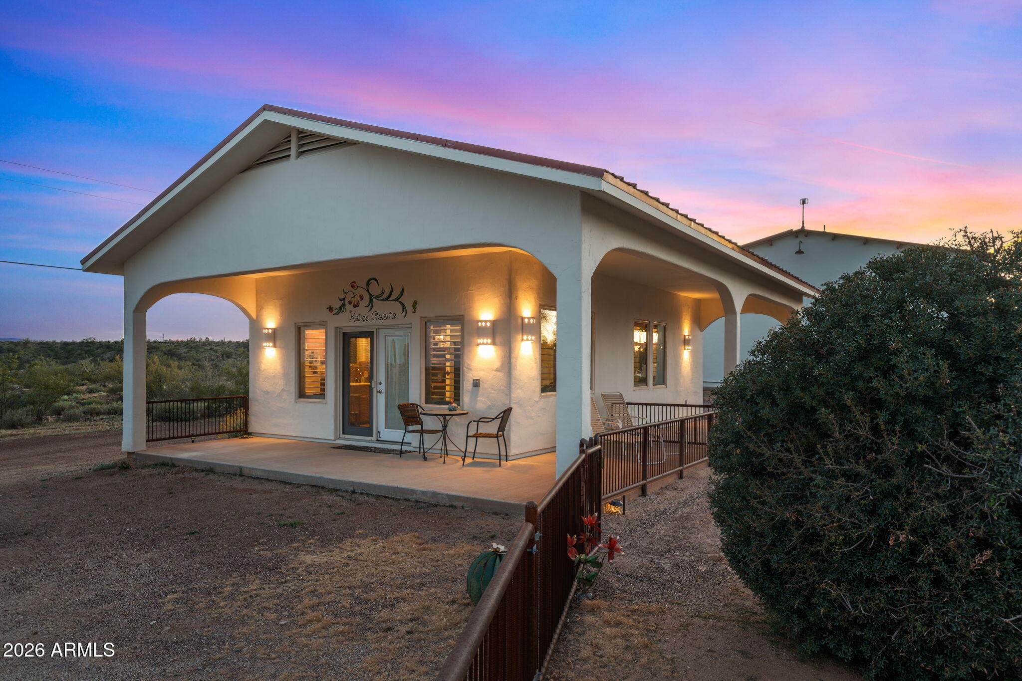18210 Moonlight Mesa Road Wickenburg, AZ 85390 - Photo 58 of 141 a view of a house with large windows and a yard