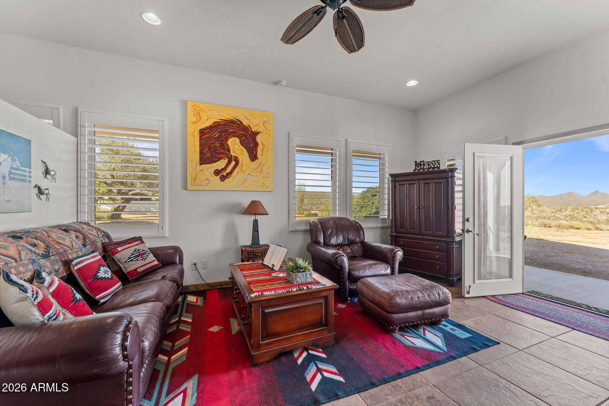 18210 Moonlight Mesa Road Wickenburg, AZ 85390 - Photo 73 of 141 a living room with furniture gym equipment and a large window