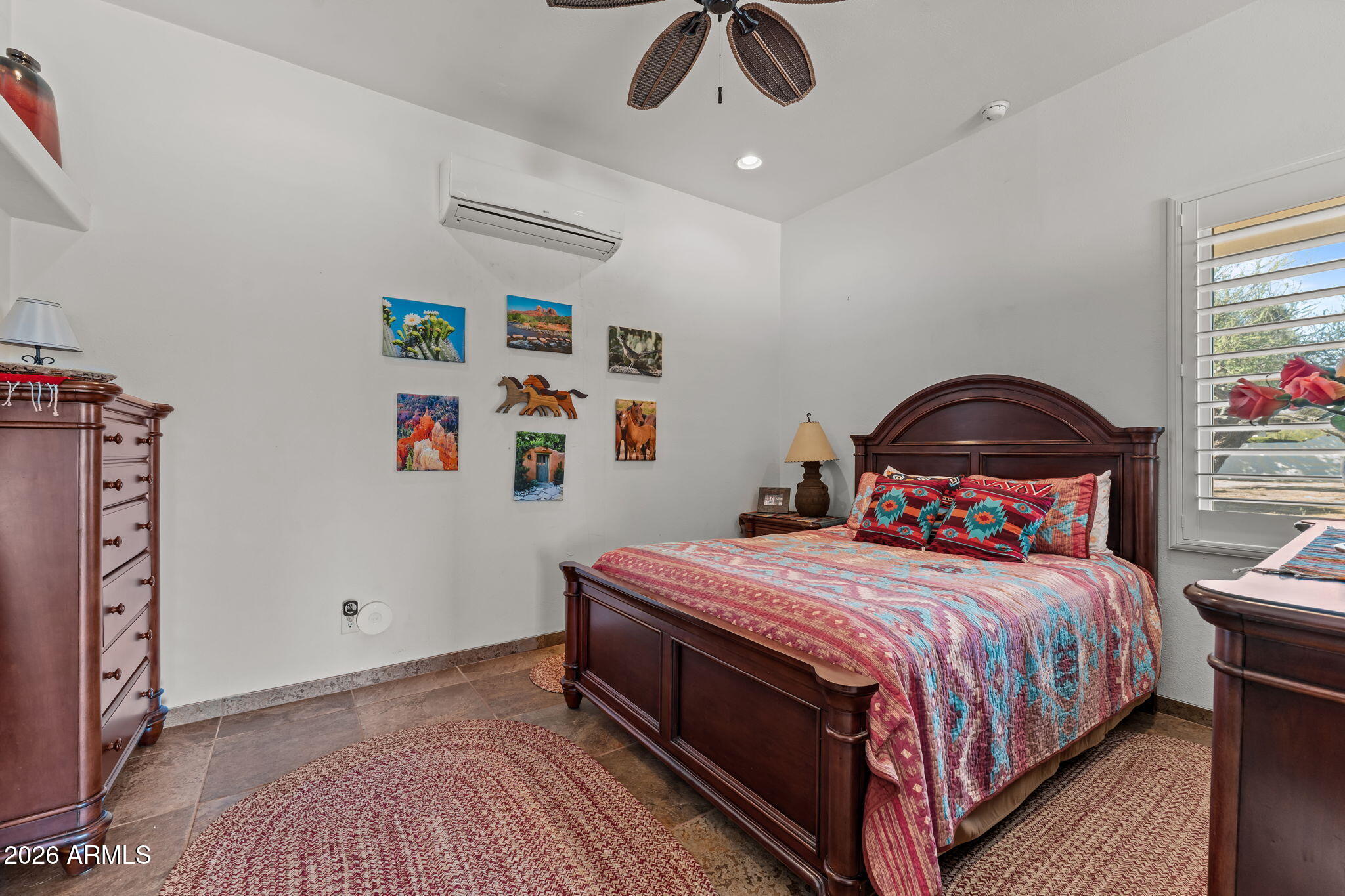 18210 Moonlight Mesa Road Wickenburg, AZ 85390 - Photo 75 of 141 a bedroom with a bed and a chandelier