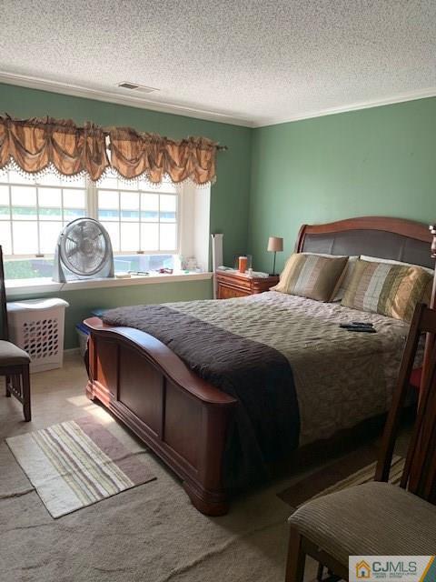 125 Edpas Road, Unit 125 New Brunswick, NJ 08901 - Photo 2 of 9 a bedroom with a bed lamp and a large window