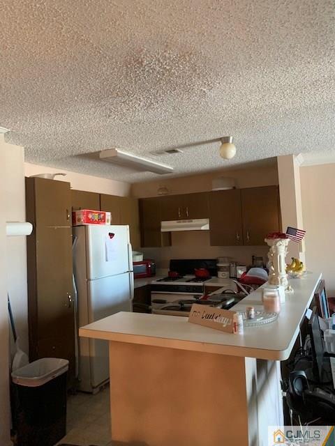 125 Edpas Road, Unit 125 New Brunswick, NJ 08901 - Photo 4 of 9 a kitchen with a refrigerator and a stove