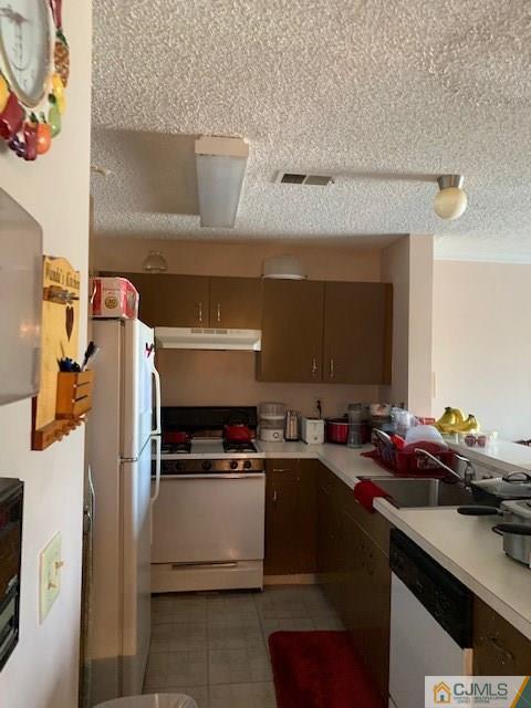 125 Edpas Road, Unit 125 New Brunswick, NJ 08901 - Photo 5 of 9 a kitchen with a sink refrigerator and cabinets