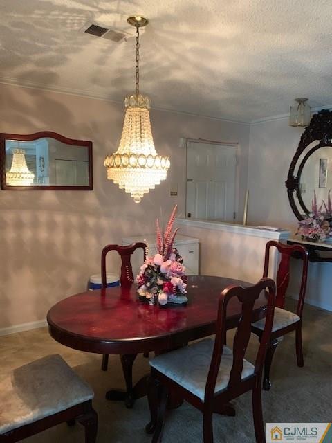 125 Edpas Road, Unit 125 New Brunswick, NJ 08901 - Photo 9 of 9 a view of a dining room and a chandelier