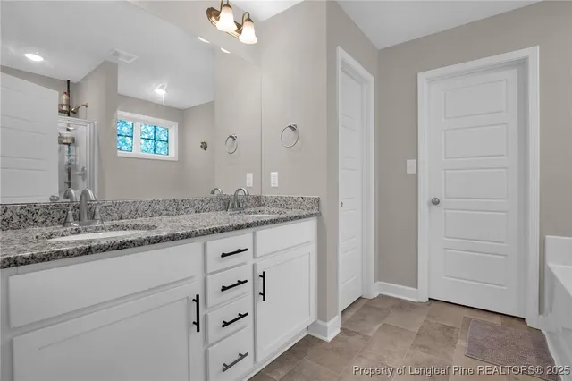 a bathroom with a granite countertop sink two mirror and a