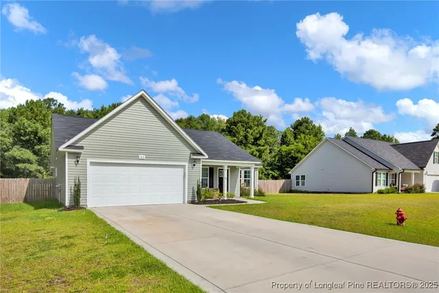 a view of house that has a yard