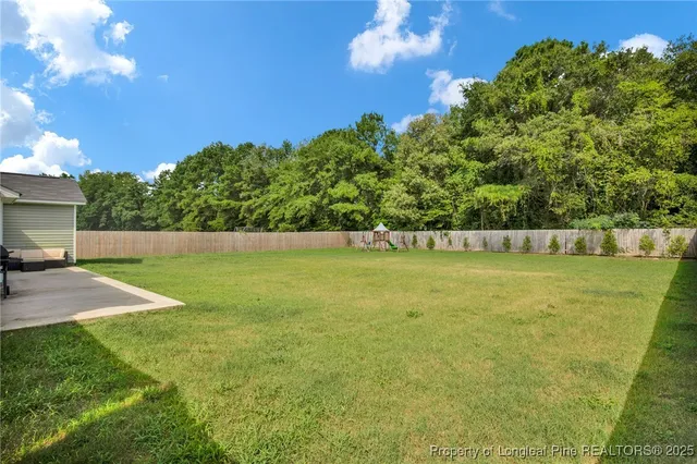 a front view of house with a garden