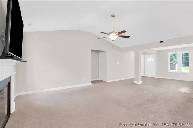 a view of an empty room with a fireplace