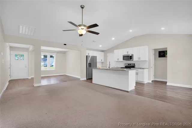 a view of kitchen with refrigerator and window