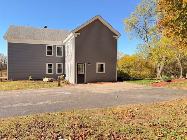 a view of a yard with snow on the road
