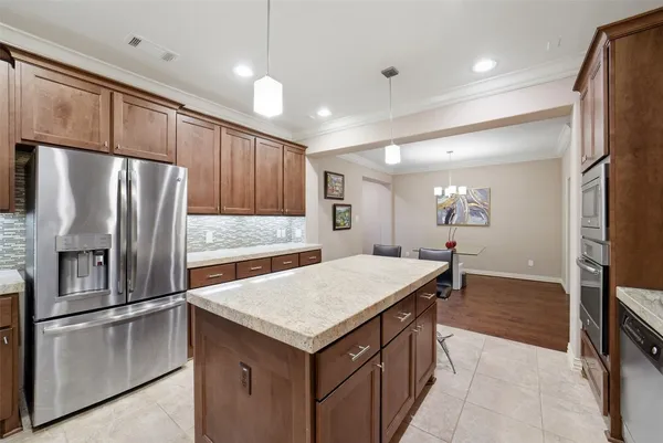 a kitchen with granite countertop a refrigerator and a sink