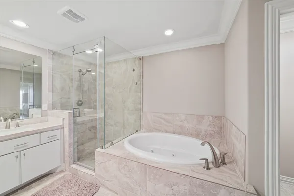 a bathroom with a tub a sink shower and mirror