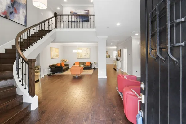 a view of entryway livingroom and hall with wooden floor