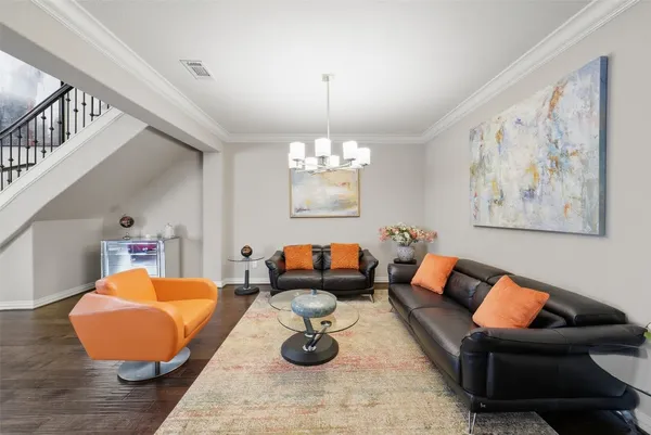 a living room with furniture and a chandelier
