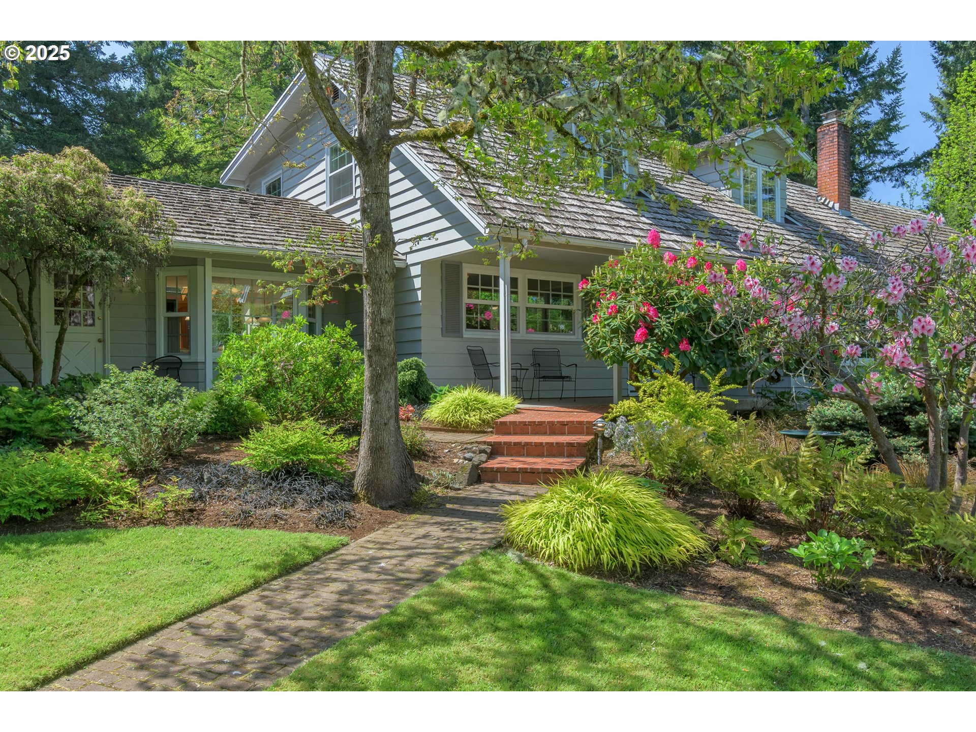 a view of a house with backyard sitting area and garden