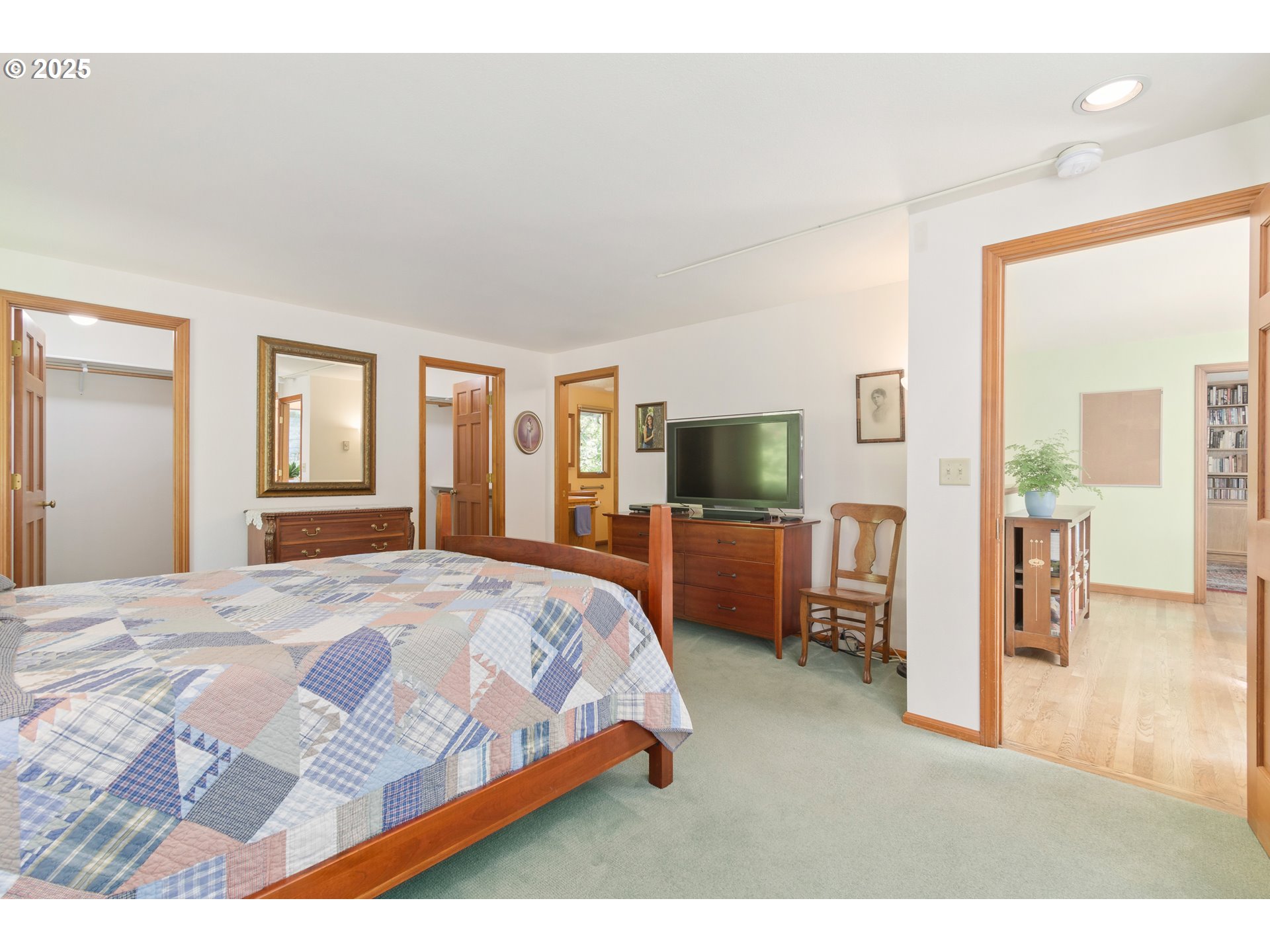 888 Crest Drive Eugene, OR 97405 - Photo 22 of 48 a bedroom with a large bed and a flat tv screen on dresser