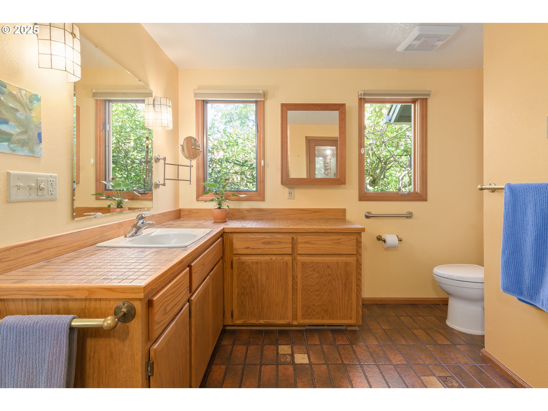 888 Crest Drive Eugene, OR 97405 - Photo 24 of 48 a bathroom with a granite countertop sink toilet a large mirror and a bathtub