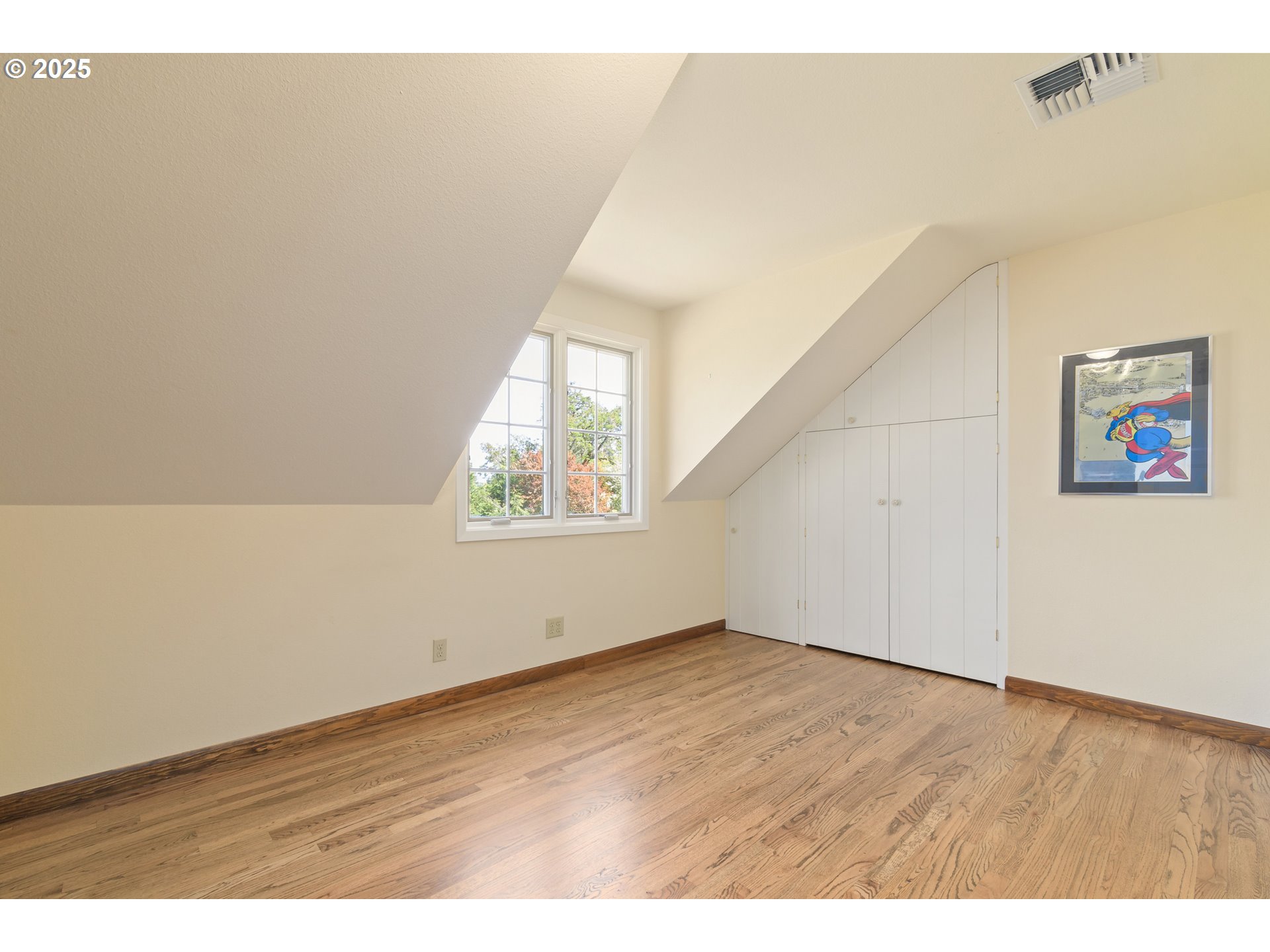 888 Crest Drive Eugene, OR 97405 - Photo 29 of 48 an empty room with wooden floor and windows