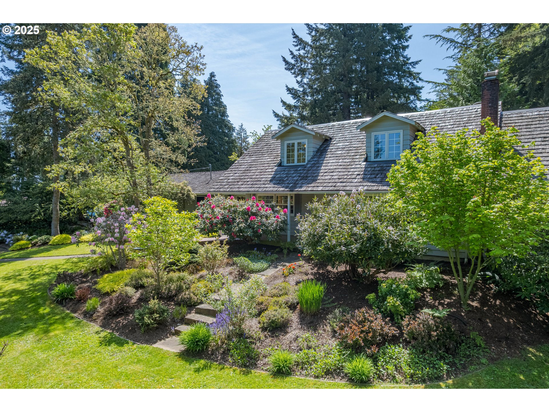 888 Crest Drive Eugene, OR 97405 - Photo 3 of 48 a view of a house with a yard and plants