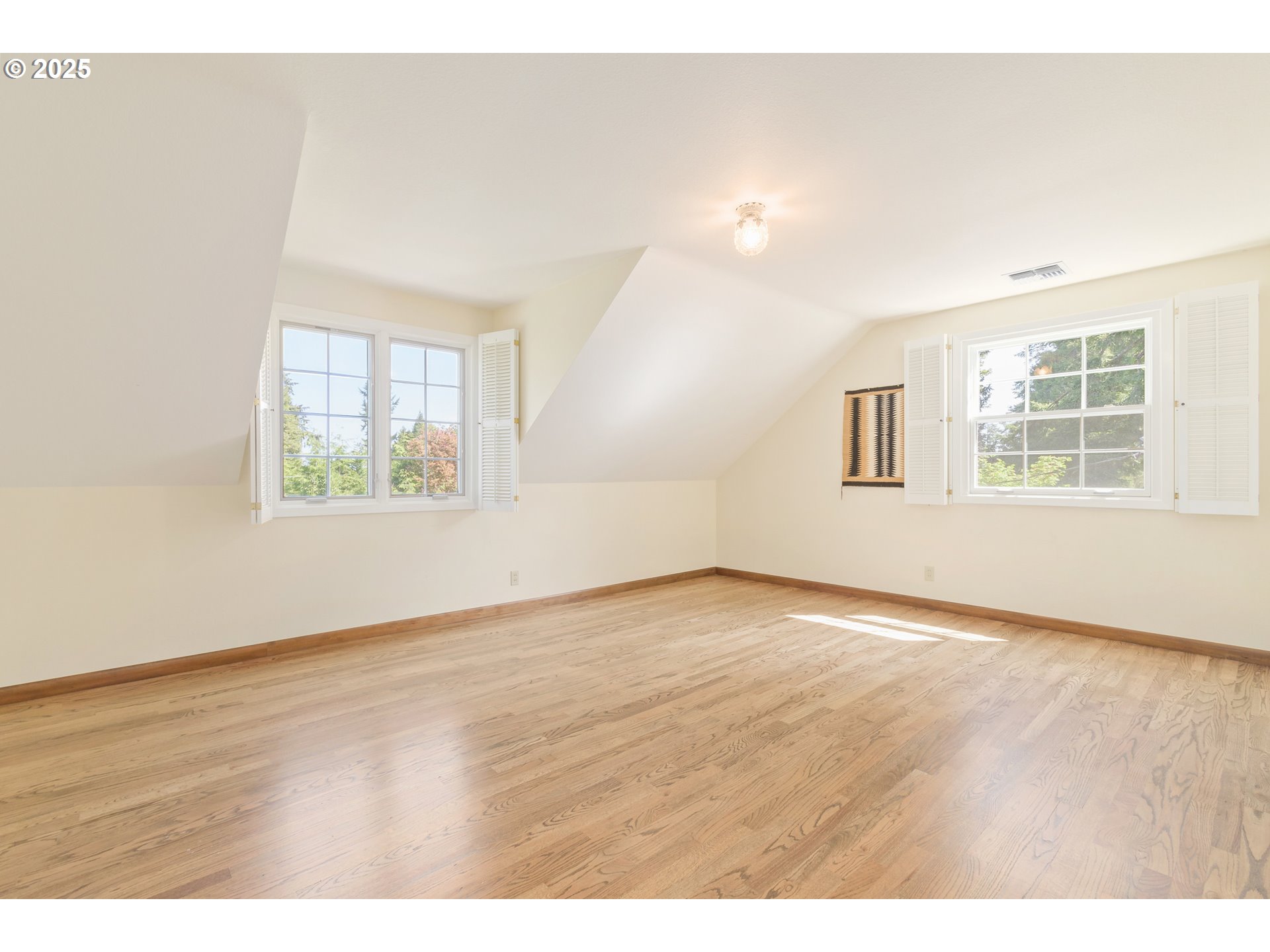 888 Crest Drive Eugene, OR 97405 - Photo 32 of 48 an empty room with wooden floor and windows