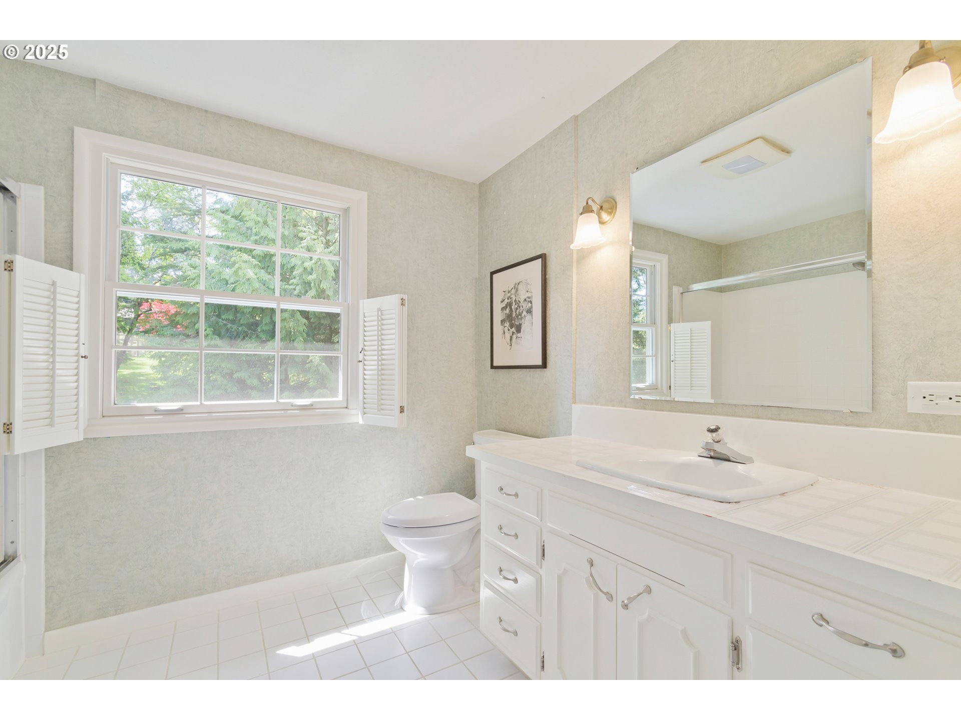 888 Crest Drive Eugene, OR 97405 - Photo 36 of 48 a bathroom with a sink toilet a mirror and a window