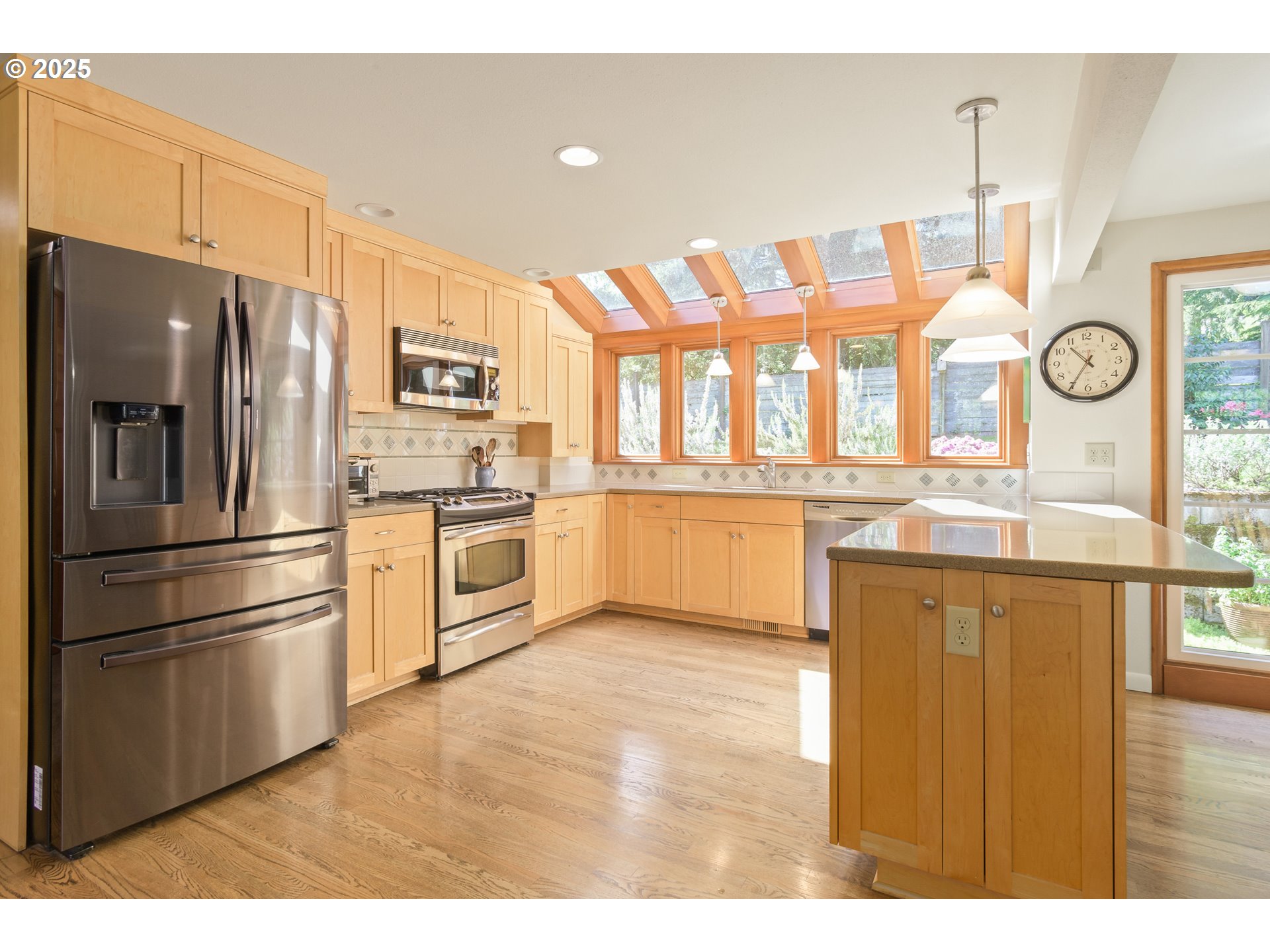 888 Crest Drive Eugene, OR 97405 - Photo 7 of 48 a kitchen with stainless steel appliances granite countertop a refrigerator a stove and a sink