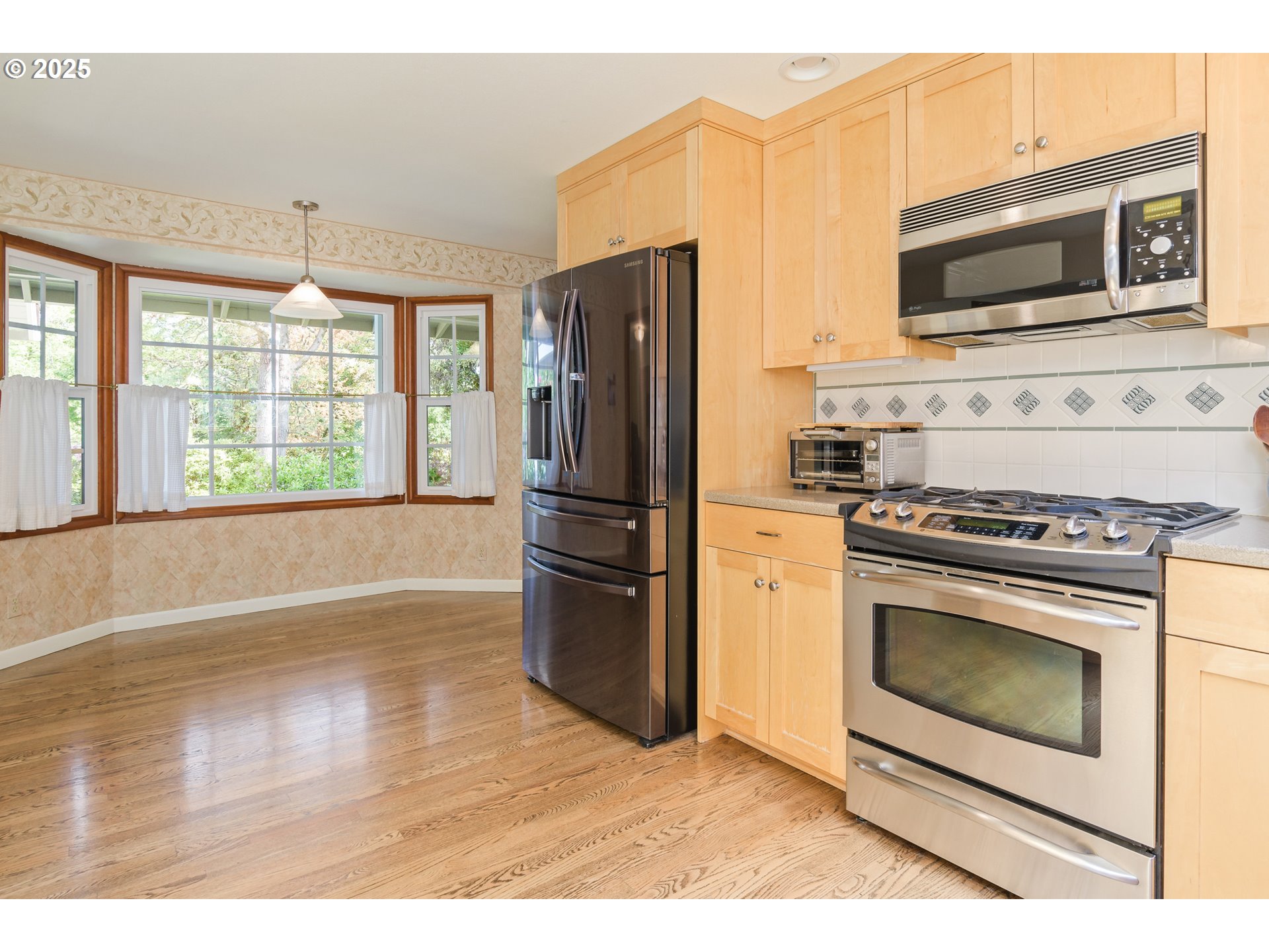 888 Crest Drive Eugene, OR 97405 - Photo 10 of 48 a kitchen with granite countertop a refrigerator stove and microwave