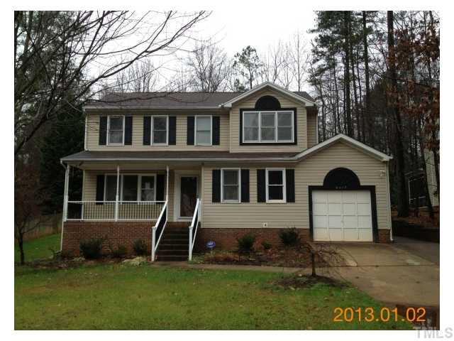 6617 Hammersmith Drive Raleigh, NC 27613 - Photo 1 of 13 a front view of a house with a garden and yard