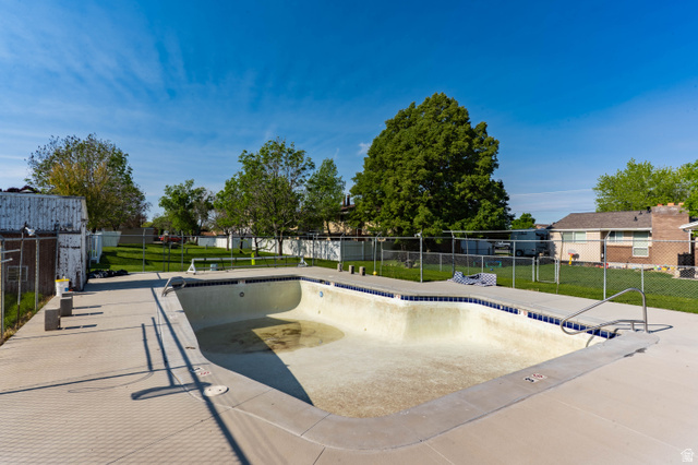 728 400 East Orem, UT 84097 - Photo 29 of 30 In-ground swimming pool with a concrete surround and integrated diving board