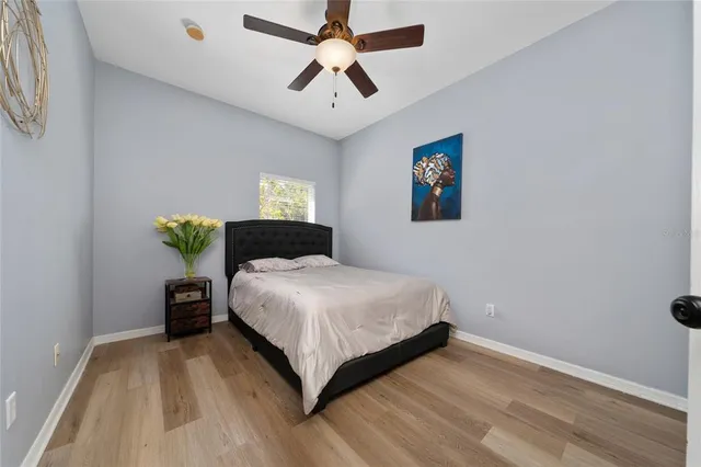 a bedroom with a bed and a chandelier