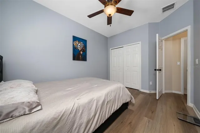 a bedroom with a large bed and a chandelier