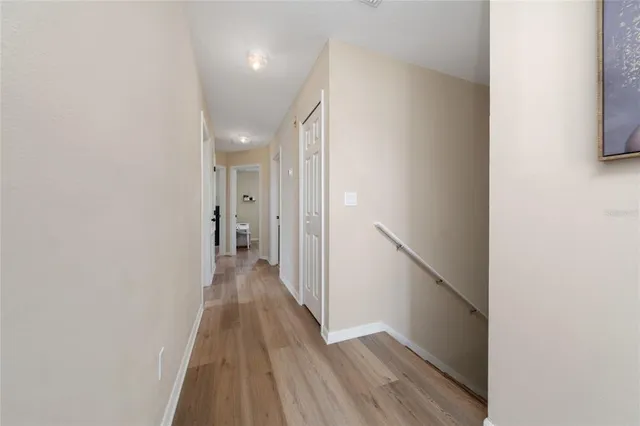 a view of a hallway with wooden floor