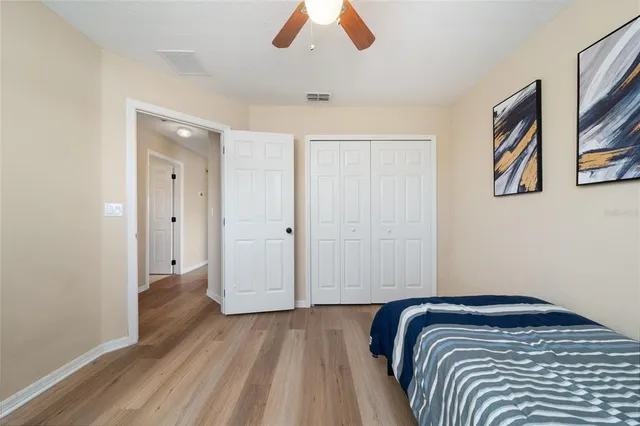 a bedroom with a bed and painting on the wall