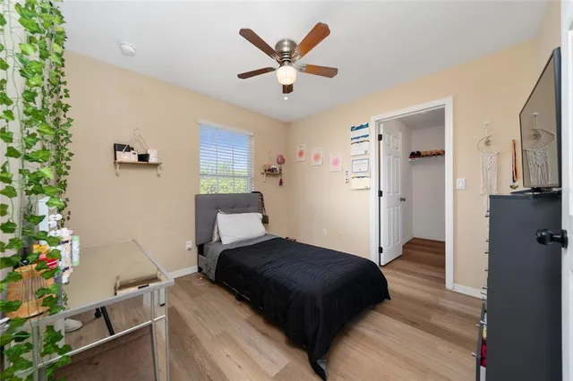 a bedroom with a bed and a potted plant