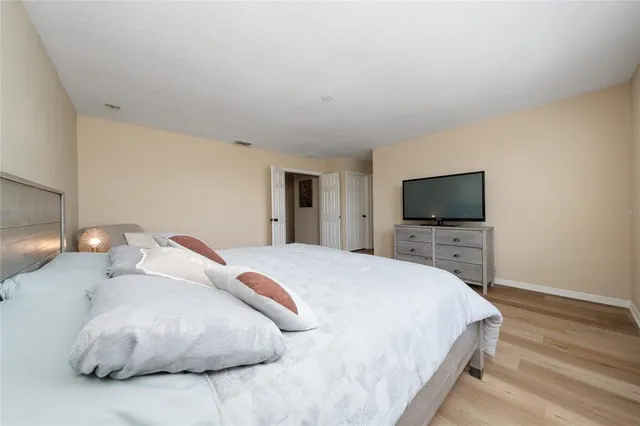 a bedroom with a bed and a flat screen tv