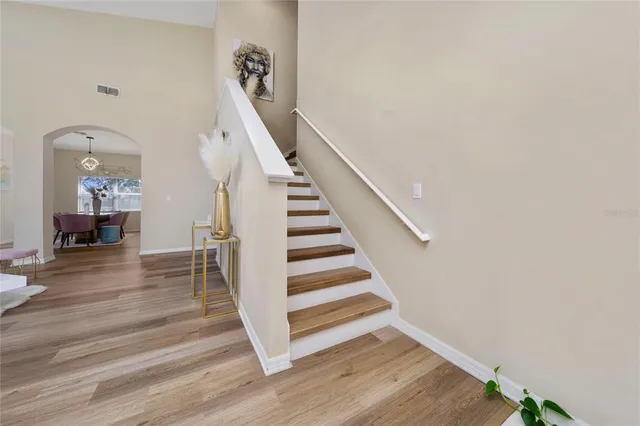 a view of entryway and hall with wooden floor