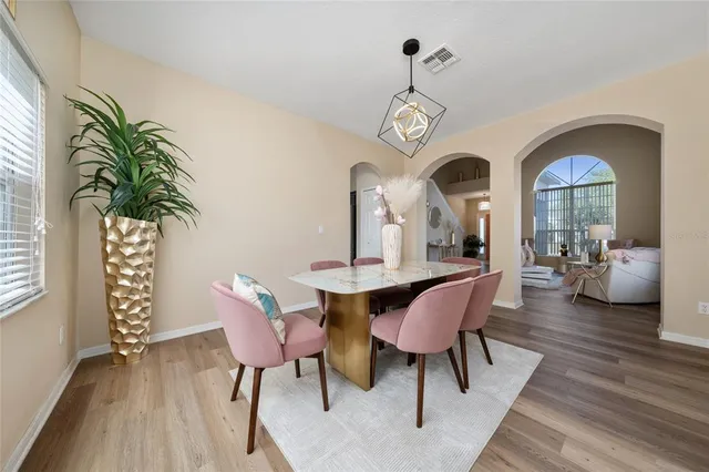 a view of a dining room with furniture window and wooden floor