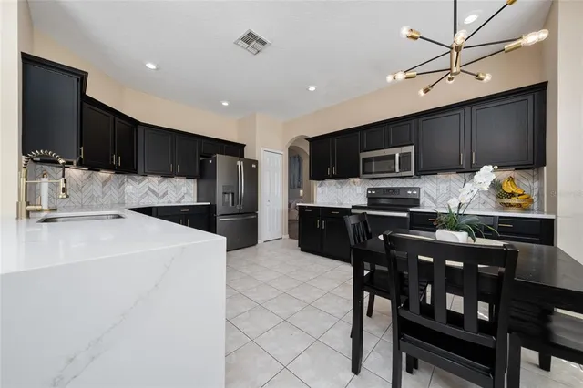 a kitchen with stainless steel appliances a stove sink microwave and cabinets