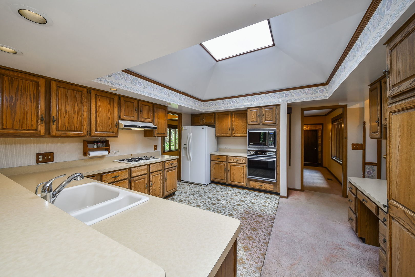 6N347 Old Homestead Road St. Charles, IL 60175 - Photo 10 of 25 a kitchen with stainless steel appliances granite countertop a sink refrigerator and cabinets