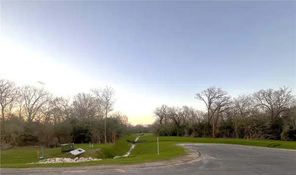 a view of a lake with houses in the background