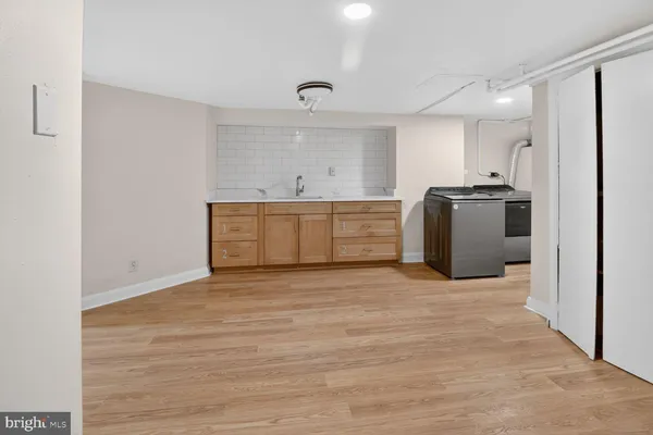 a view of kitchen with refrigerator cabinets and wooden floor