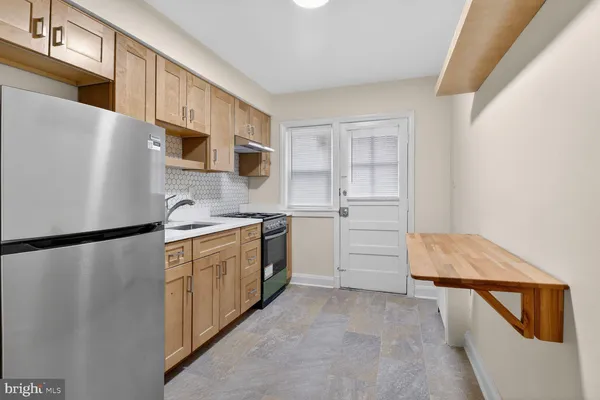 a kitchen with a refrigerator a stove a microwave and cabinets