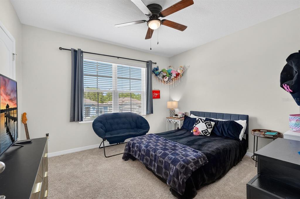 1809 Myrtlebrooke Drive Edgewater, FL 32141 - Photo 27 of 58 a bedroom with a large bed and a window