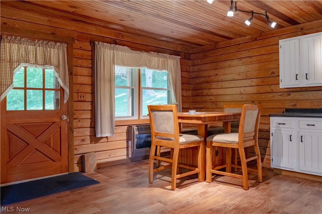 36048 South 16 Road Barnesville, OH 43713 - Photo 12 of 45 Dining area featuring a wealth of natural light, wooden ceiling, light wood-type flooring, and rail lighting