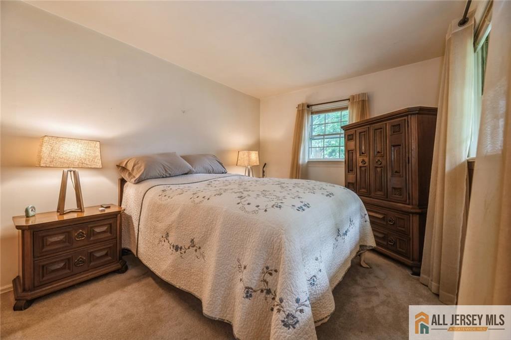 129 Cottrell Road Old Bridge, NJ 07747 - Photo 11 of 25 a bedroom with a bed and a lamp on dresser