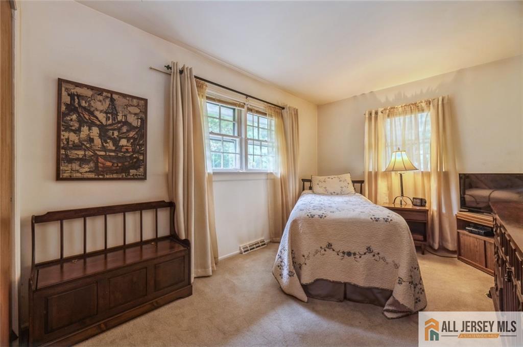 129 Cottrell Road Old Bridge, NJ 07747 - Photo 14 of 25 a spacious bedroom with a bed and a window