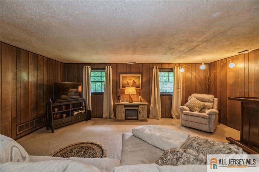 129 Cottrell Road Old Bridge, NJ 07747 - Photo 17 of 25 a living room with furniture and a flat screen tv