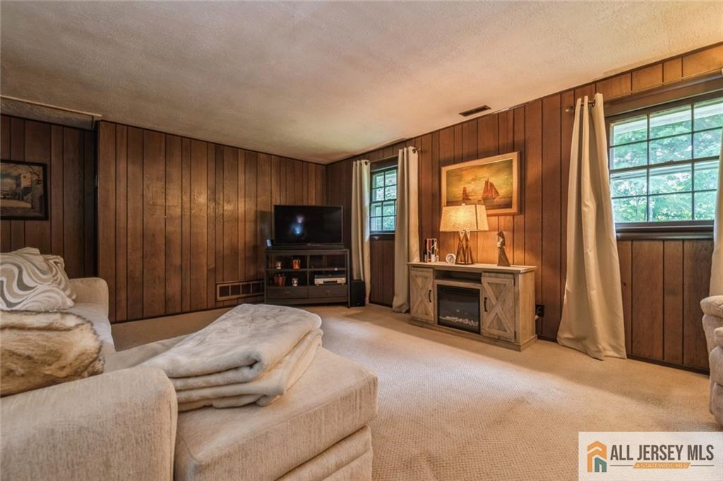 129 Cottrell Road Old Bridge, NJ 07747 - Photo 19 of 25 a living room with furniture and a fireplace