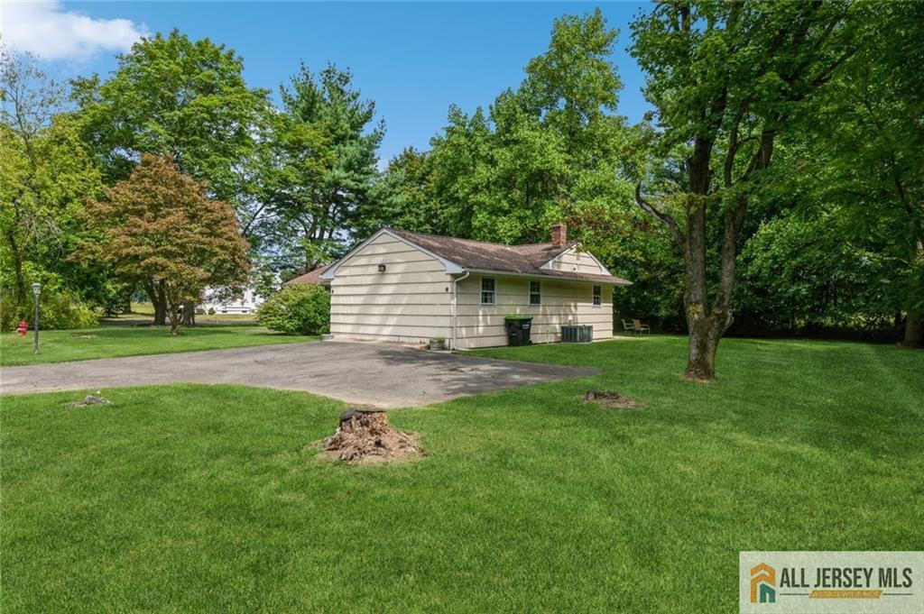 129 Cottrell Road Old Bridge, NJ 07747 - Photo 21 of 25 a front view of a house with a yard