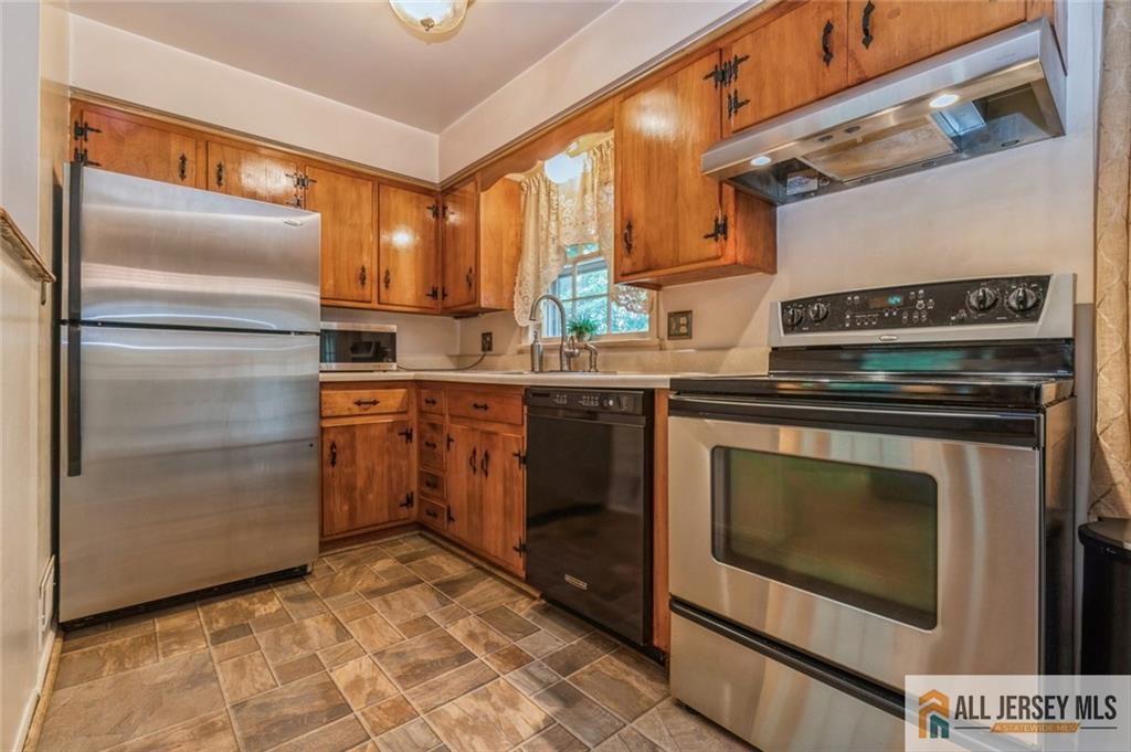 129 Cottrell Road Old Bridge, NJ 07747 - Photo 6 of 25 a kitchen with a stove sink and refrigerator